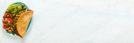 banner of vegan breakfast of gluten-free egg-free chickpea omelet with fried mushrooms and leek. and a salad of fresh ripe tomatoes, avocados, olives and capers. healthy food for the whole family, party or restaurant menuの写真素材