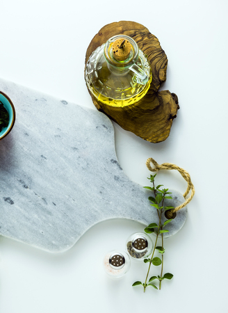 empty marble cutting board on a white tableの写真素材