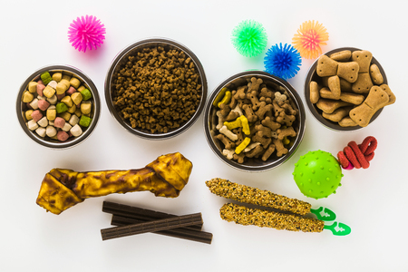 pet food in bowls and toys isolated on white backgroundの写真素材