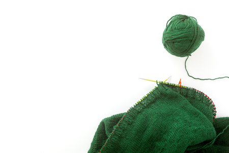 knitting a sweater with knitting needles and a cup of coffee. background for yarn and knittingの写真素材