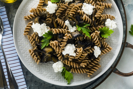 gluten-free pasta from half-wheat farro flour with portobello mushrooms and ricotta cheese on a tray on a marble table. healthy vegetarian recipesの写真素材