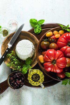 ingredients for the preparation of summer salad of colorful tomatoes, olives and ricotta. Mediterranean recipesの写真素材