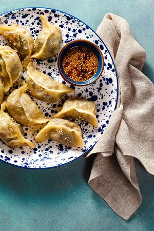 Wonton dumplings with spicy sesame sauce on the table. tasty foodの写真素材