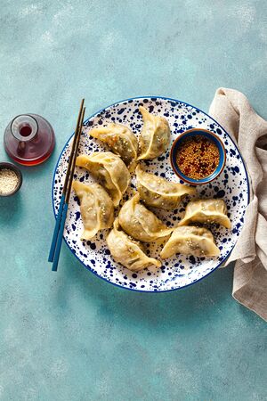 Wonton dumplings with spicy sesame sauce on the table. tasty foodの写真素材