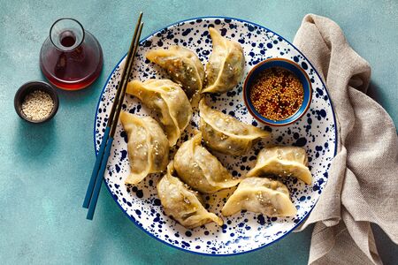 Wonton dumplings with spicy sesame sauce on the table. tasty foodの写真素材