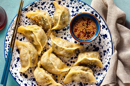 Wonton dumplings with spicy sesame sauce on the table. tasty foodの写真素材