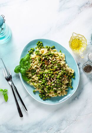 spring homemade Italian pasta with chickpea flour and pesto with fresh green peas and pine nuts. delicious mediterranean cuisineの写真素材