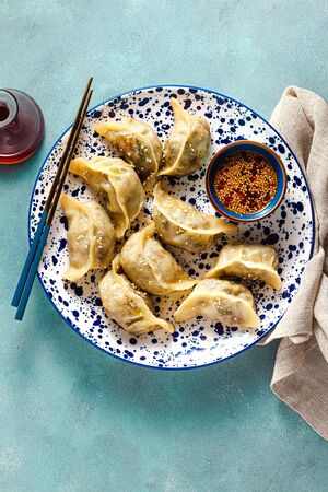 Wonton dumplings with spicy sesame sauce on the table. tasty foodの写真素材