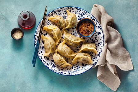 Wonton dumplings with spicy sesame sauce on the table. tasty foodの写真素材