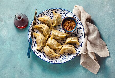 Wonton dumplings with spicy sesame sauce on the table. tasty foodの写真素材