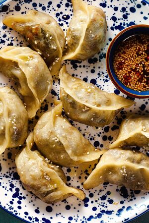 Wonton dumplings with spicy sesame sauce on the table. tasty foodの写真素材