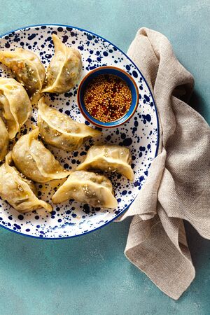 Wonton dumplings with spicy sesame sauce on the table. tasty foodの写真素材