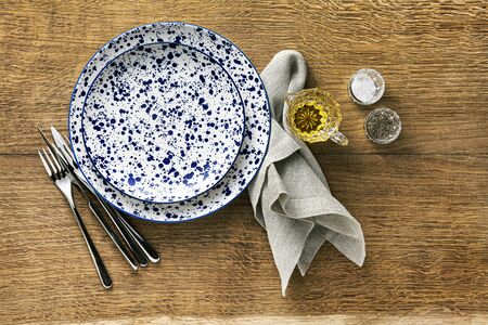 empty plates on the wooden  table. serving lunch or dinner. space for copy textの写真素材