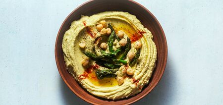 banner of hummus with green asparagus. spring alternative recipeの写真素材