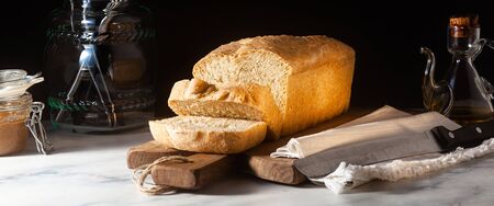 banner of Fresh homemade Toast bread on the kitchen table, dark background.の写真素材