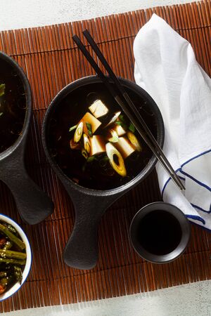 Japanese breakfast with miso soup, onigiri and vegetables in sweet and sour sauce. Typical traditional morning foodの写真素材