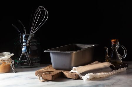 a baking tray for baking bread on the kitchen table, dark backgroundの写真素材