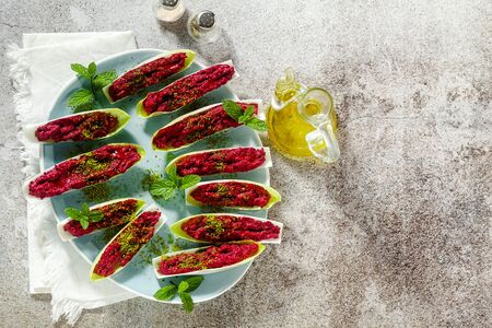 dip of boiled beets and pistachios in leaves of Belgian Endive with mint. healthy summer snackの写真素材