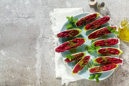 dip of boiled beets and pistachios in leaves of Belgian Endive with mint. healthy summer snackの写真素材