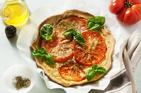 summer vegan pie galette with tomatoes and tofu in oat milk. tasty snack or healthy food lunchの写真素材