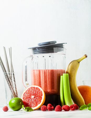 smoothies in a glass blender bowl and ingredients on the table. Not disposable metal tubes. Healthly food.の写真素材