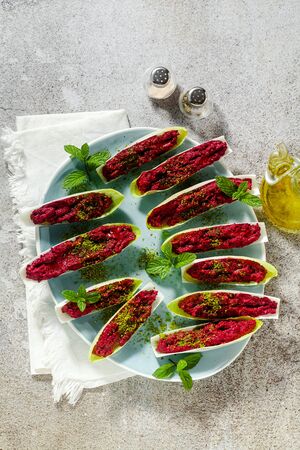 dip of boiled beets and pistachios in leaves of Belgian Endive with mint. healthy summer snackの写真素材