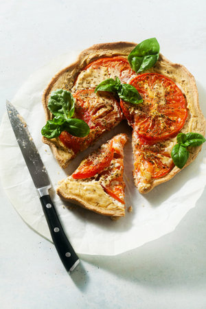 summer vegan pie galette with tomatoes and tofu in oat milk. tasty snack or healthy food lunch