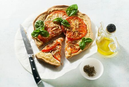 summer vegan pie galette with tomatoes and tofu in oat milk. tasty snack or healthy food lunchの写真素材