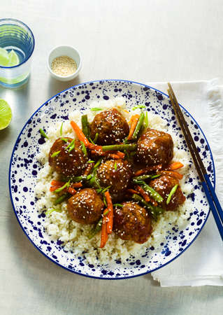 meatless vegan Asian meatballs in sweet and sour sauce with rice and stewed vegetables. balanced lunch or healthy dinner. street foodの写真素材