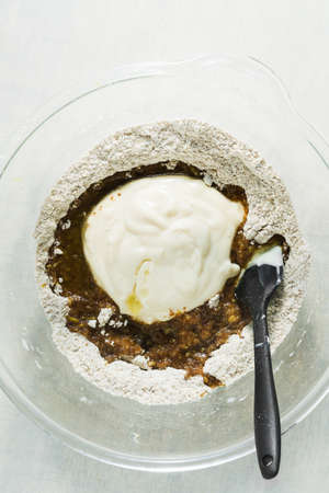 mixing sweet baking ingredients in a large glass bowlの写真素材