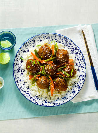 meatless vegan Asian meatballs in sweet and sour sauce with rice and stewed vegetables. balanced lunch or healthy dinner. street foodの写真素材