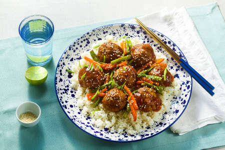 meatless vegan Asian meatballs in sweet and sour sauce with rice and stewed vegetables. balanced lunch or healthy dinner. street foodの写真素材