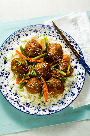 meatless vegan Asian meatballs in sweet and sour sauce with rice and stewed vegetables. balanced lunch or healthy dinner. street foodの写真素材