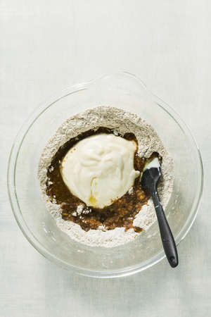 mixing sweet baking ingredients in a large glass bowlの写真素材