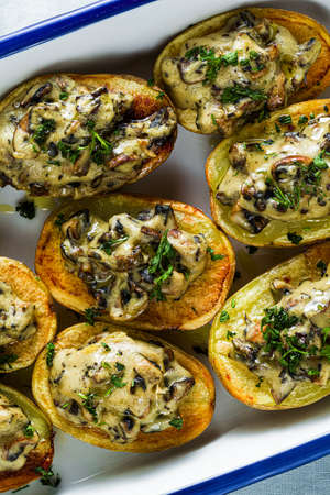 vegan baked potatoes with mushrooms in bechamel sauce with soy milk. healthy lunch or dinner for the familyの写真素材