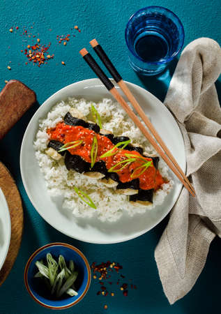 fried tofu wrapped in nori with tomato-coconut sauce and rice for sushi. vegan modern cuisineの写真素材