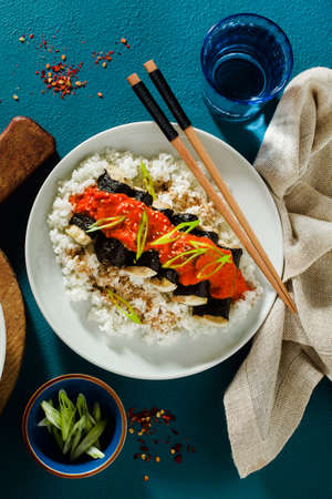 fried tofu wrapped in nori with tomato-coconut sauce and rice for sushi. vegan modern cuisineの写真素材