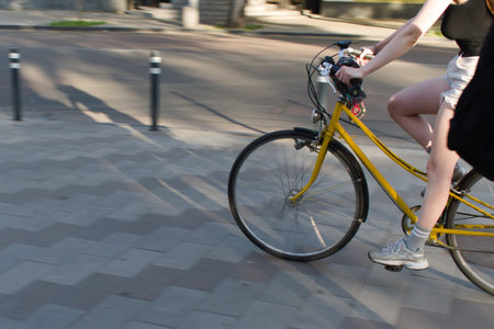 woman rides a bicycle, the main object is in motion, blurred background