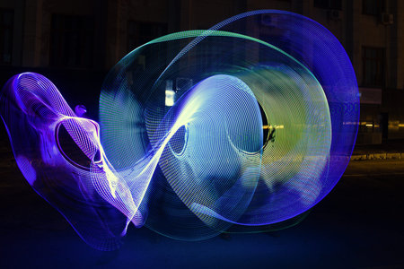 abstraction circles drawn with colorful lanterns in the night city