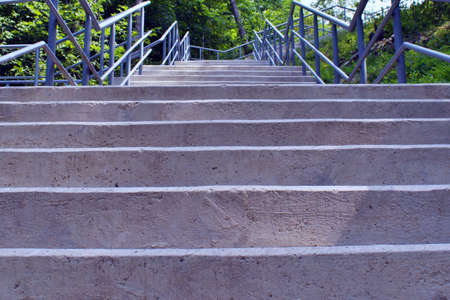 staircase concrete and metal leading to the uphillの写真素材