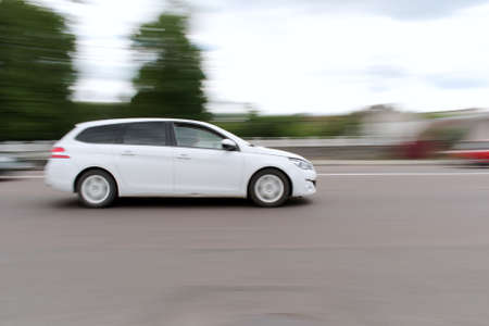 city traffic motion blurred passenger car in motionの写真素材