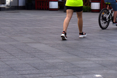 girls feet walking on the asphalt