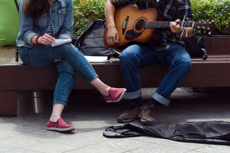 guy playing guitar for a girl on the streetの写真素材