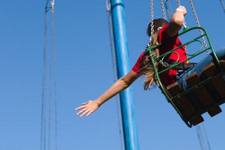 girl on air carousel stretched out her hand back