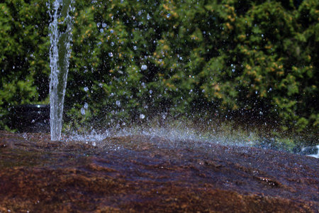 jet of water and flying splash on the stone