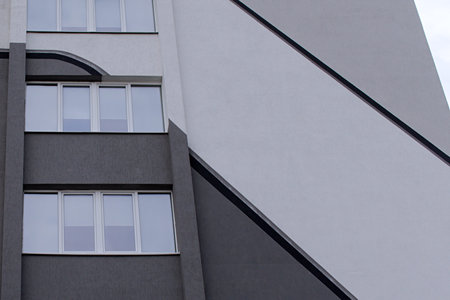 office building facade with windows and diagonal stripes