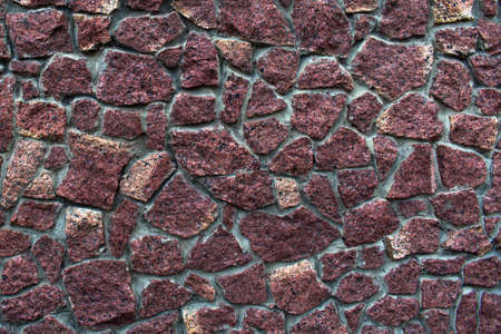 wall texture of large natural stones of red colorの写真素材