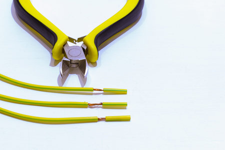 tools for electrical work and the cut wires close up on white backgroundの写真素材
