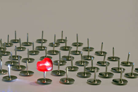 shining bright red pomegranate seed impaled on pin on blurred backgroundの写真素材