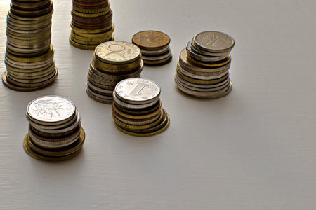 coins of different countries and denominations on painted table